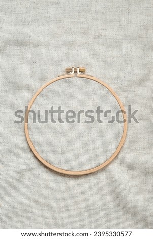 Wooden embroidery hoop with canvas as background