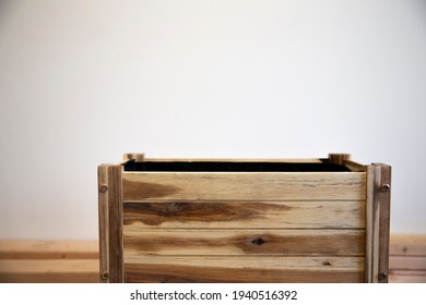 Wooden Empty Rectangular Pot For Plants On White Wall Background. Wooden Planter, Raised Bed