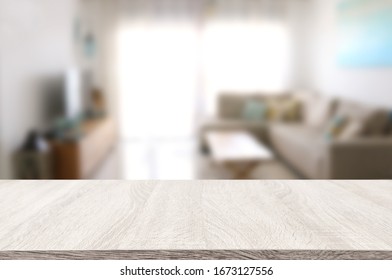Wooden empty table in front of Living room sofa interior. For product display and presentation - Shutterstock ID 1673127556