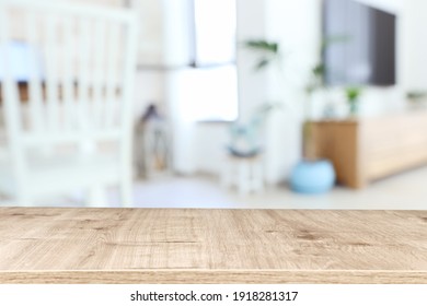 Wooden Empty Table In Front Of Living Room Interior. For Product Display And Presentation