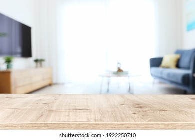 Wooden Empty Table In Front Of Living Room Sofa Interior. For Product Display And Presentation