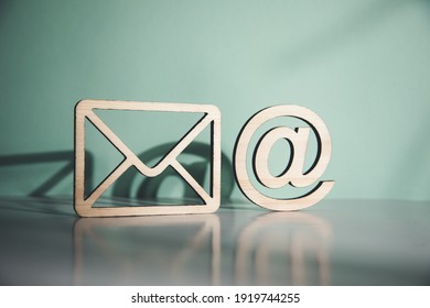 wooden envelope letter and e mail symbols on table - Shutterstock ID 1919744255