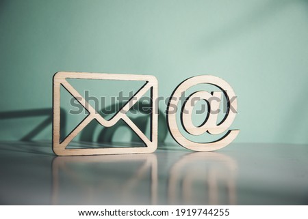 wooden envelope letter and e mail symbols on table