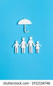 Wooden Family Figure Under Umbrella With Space For Text. Insurance Concept