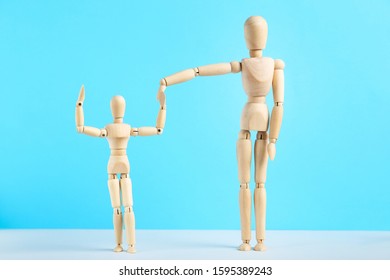 Wooden family figures on blue background