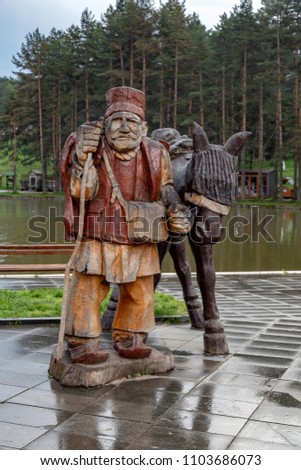 Wooden farmer with horse 2,6 m high carved from tree by a chainsaw at Zlatibor, Serbia.