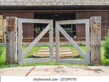 wooden fence of barn with group of animal inside