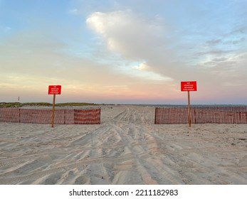 A Wooden Fence Barrier And Two Red Signs That Say 