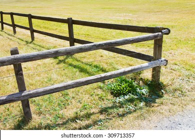 Wooden Fence In A Green Meadow Just Shaved