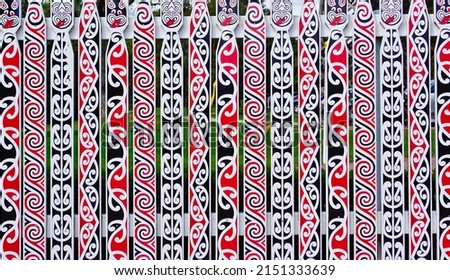 Wooden fence painted with Māori artistic patterns rotorua New Zealand 