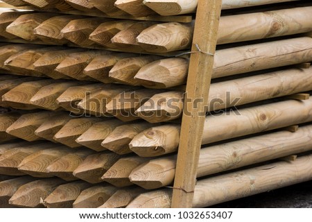 Wooden fence posts, round wood piles