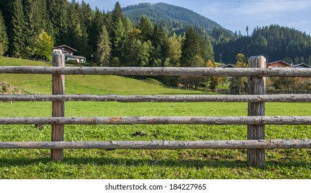 Wooden Fence At Ranch And Green Background