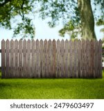 Wooden fence, tree and green grass outdoors