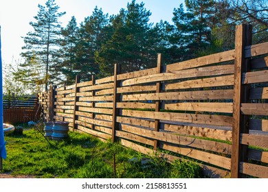 wooden fence in the village on the edge of the forest