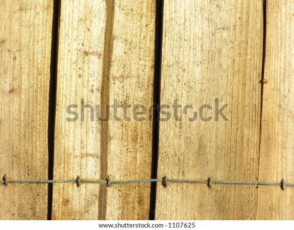 Wooden fence with wire\
connected pieces