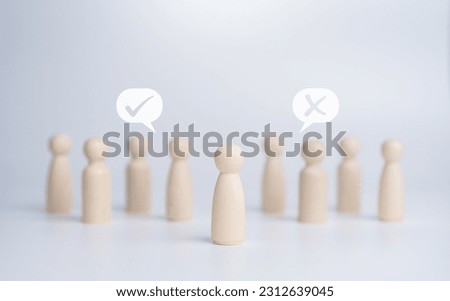 Wooden figure dolls stand in the middle among others with vote yes or no symbol. Open-mindedness, public hearing, elections, voting concept. Idea for Volunteers, candidates, constituency electorates.