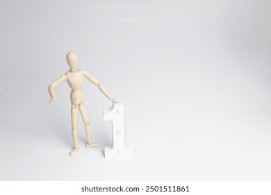 wooden figure of a man with a white big number one - Powered by Shutterstock