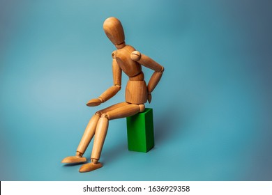 Wooden figure sitting on a green chair. Concept of the problem with digestion. Dysentery - Shutterstock ID 1636929358