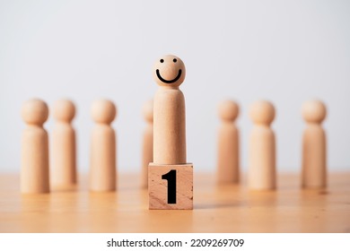 Wooden Figure Standing On Number One Podium With Smile Face For Successful Winner Promotion And Team Leadership Concept.