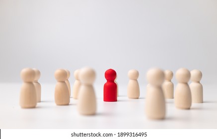 A Wooden Figure Standing With A Team To Influence And Empowerment. Concept Of Leadership, Successful Competition Winner And Leader With Influence And Social Distancing For A New Normal Lifestyle