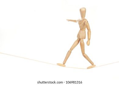 wooden figure walking on rope. concepts - Powered by Shutterstock