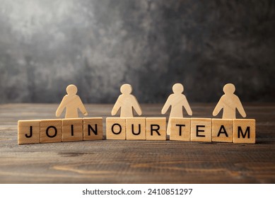 Wooden figures and wooden cubes with Join Our Team letters on a wooden table. Human resources management concept - Powered by Shutterstock