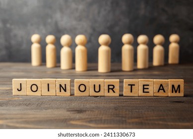 Wooden figures and wooden cubes with Join Our Team letters on a wooden table. Human resources management concept - Powered by Shutterstock