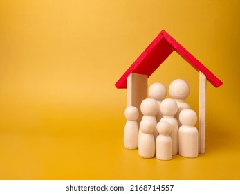 Wooden Figures Inside Wooden House With Copy Space. Concept Of Family And House.