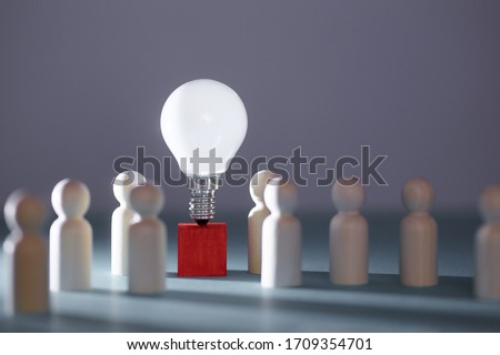 Wooden figures, lightbulb on red cube. Team creativity, idea mockup. Creative approach and lateral thinking, copy space