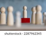 Wooden figures and peg dolls standing on the red podium 1st positions of wooden cube blocks. Ranking and strategy concept. Leadership concept and business strategy. Selective focus