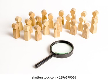 Wooden figures of people look at the magnifying glass. Search for answers to questions, searches for home or work. Problem solving and tasks. Search for a national idea and ideology concept - Shutterstock ID 1296599056