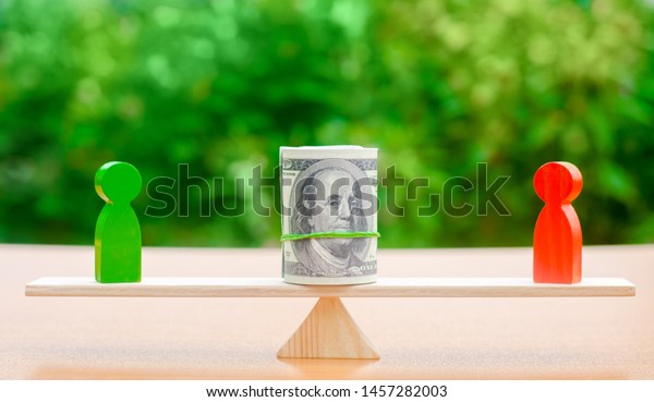 Wooden figures of people on scales and dollars\
banknotes between them. The concept of separation of money.\
Property division. Divorce and legal services. Business conflict.\
Financial dispute