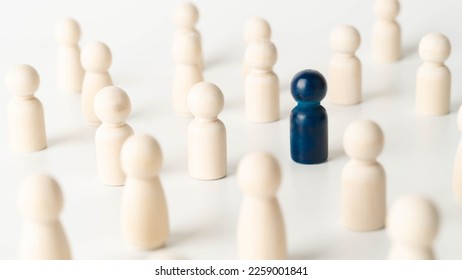 Wooden figures of people, one of them is blue. Concept of rare disease, LGBTQ, virus epidemic, spy, talent, leadership and unique. - Shutterstock ID 2259001841