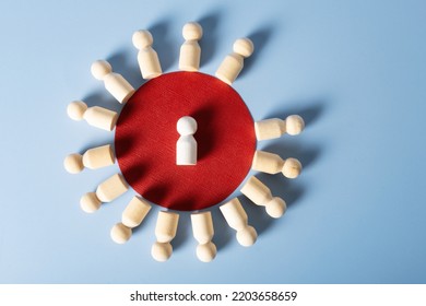 Wooden figures of people are placed in a circle, in the center of which is a white figure. The concept is the center of attention of society. - Shutterstock ID 2203658659