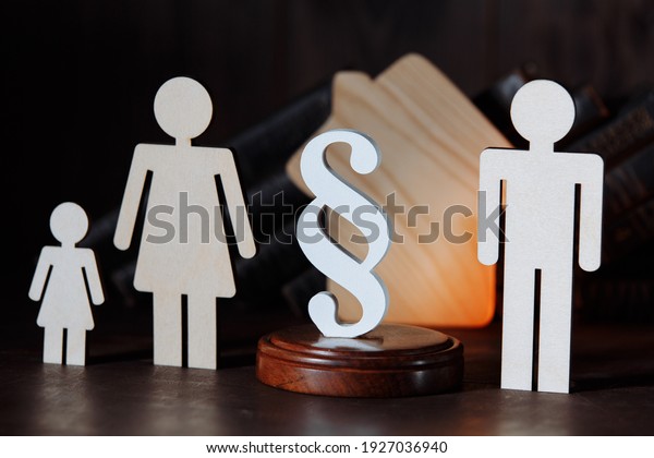 Wooden figures. Separated family with white\
paragraph sign
