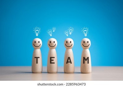 Wooden figures smile face with team wording on body and light bulb icons. Teamwork and Ideas for business corporation concept. Good Inspiration for Creation and Innovation from group Brainstorm. - Powered by Shutterstock