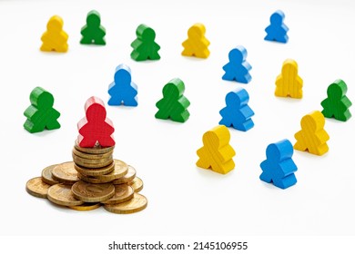 Wooden Figurine Man On A Stack Of Coins, Wealth And Social Inequality Concept