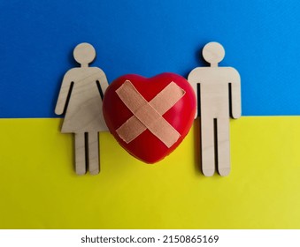 Wooden Figurines With Broken Heart On Background Of Flag Of Ukraine. Help Volunteering Ukrainians