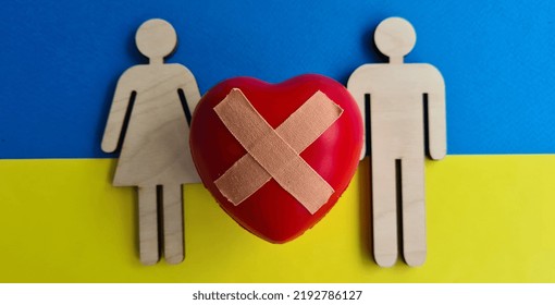 Wooden Figurines With Broken Heart On Background Of Flag Of Ukraine. Help Volunteering Ukrainians