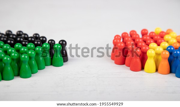 wooden figurines in the colors of\
German political parties, Green Party and Christian Democratic\
Union as government coalition and other parties as\
opposition