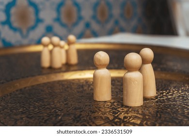 wooden figurines of people on the table. subject photo session of humanoid toys in the room. wooden toys on a bronze plate - Powered by Shutterstock