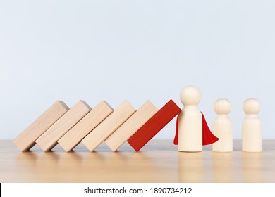 Wooden figurines representing leader stopping the domino falling over the employees. Business strategy