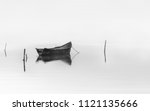 Wooden fishing boat on water.Black and white photography