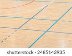 Wooden floor basketball, badminton, futsal, handball, volleyball, football, soccer court. Wooden floor of sports hall with marking lines on wooden floor indoor, gym court