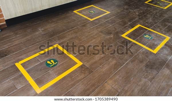 wooden floor is\
divided for social\
distancing