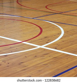 Wooden floor of sports hall with marking lines