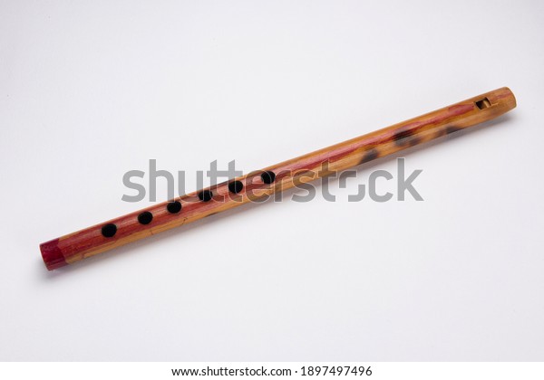 Wooden flute. Wind musical instrument on the\
white background.