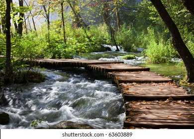 Wooden Footbridge Across Stream In The Mountain Forest, Croatia.