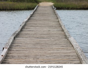 Wooden Footbridge Over Water In A Park