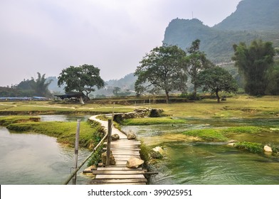 Wooden footbridge over the water of the river.